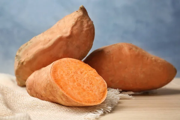 Sweet potatoes on wooden table — Stock Photo, Image