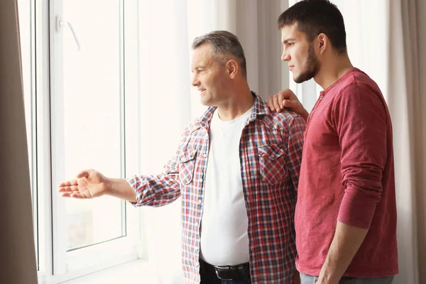 Mature man and his son at home — Stock Photo, Image