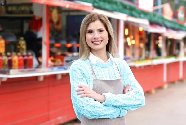 Business owner near her counter, outdoors