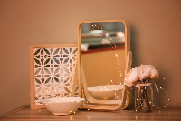 Beautiful modern mirror as decorative element on table — Stock Photo, Image