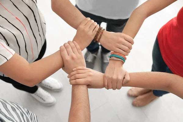 People holding hands together as symbol of unity — Stock Photo, Image