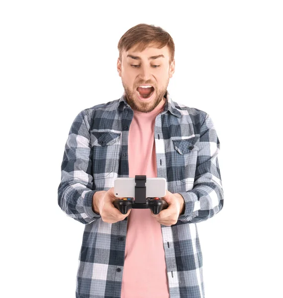 Emotional man with video game controller for smartphone on white background — Stock Photo, Image