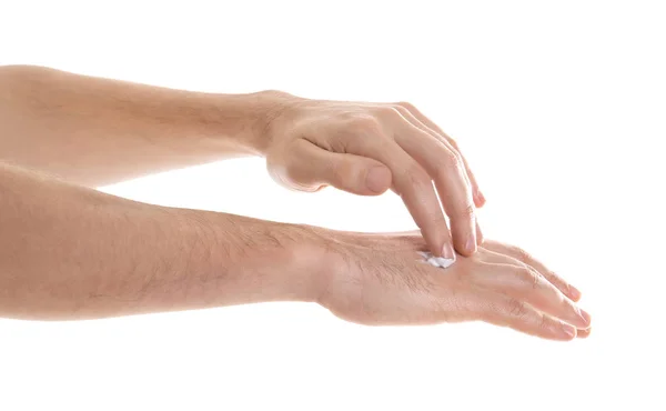 Hombre aplicando crema de manos sobre fondo blanco —  Fotos de Stock