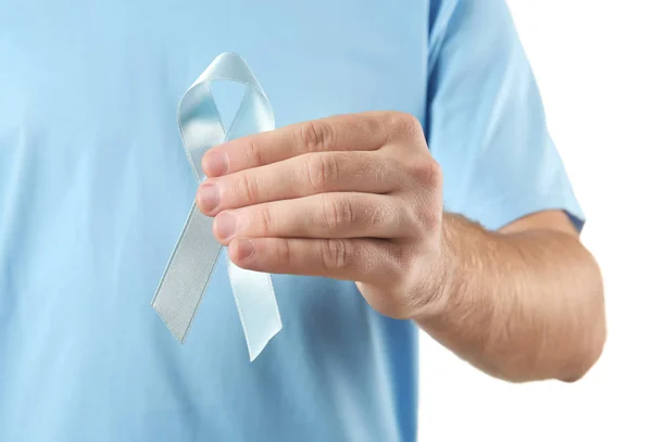 Man holding blue ribbon on white background. Cancer awareness concept — Stock Photo, Image