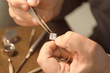 Jeweler working in workshop, closeup clipart