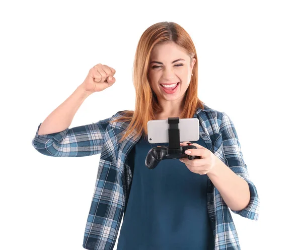 Emotionale Frau mit Videospiel-Controller für Smartphone auf weißem Hintergrund — Stockfoto