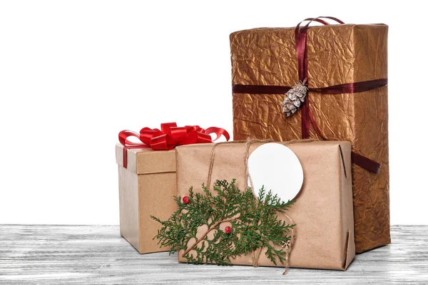 Krásné vánoční dárkové krabice na stole před bílým pozadím — Stock fotografie