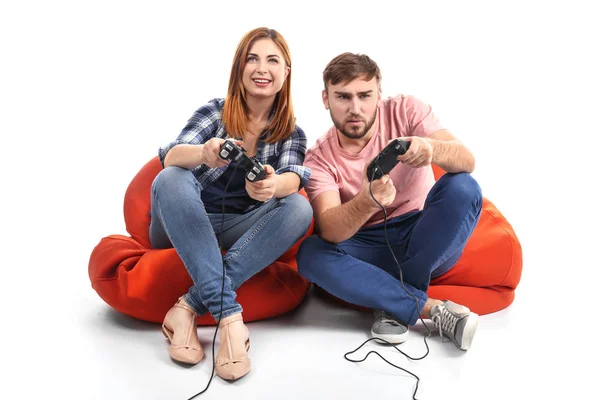 Emotional couple playing video game on white background — Stock Photo, Image