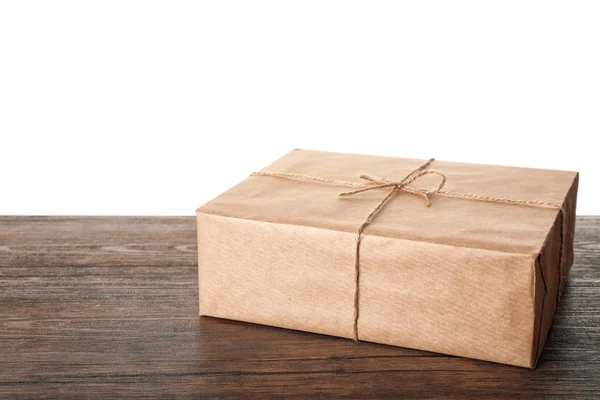 Parcel gift box on table against white background — Stock Photo, Image