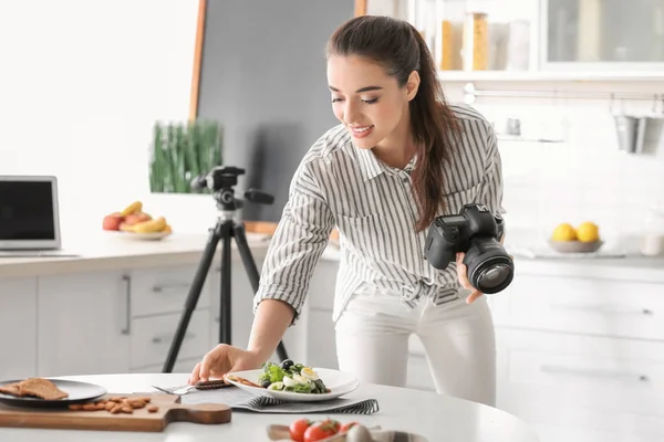 Mujer joven tomando fotos de la naturaleza muerta en la cocina — Foto de Stock