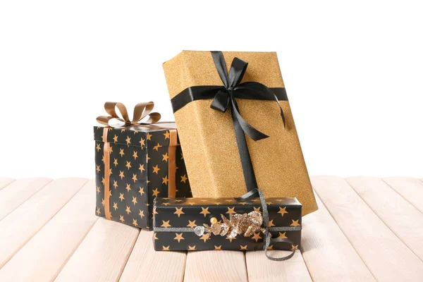 Beautiful gift boxes on table against white background