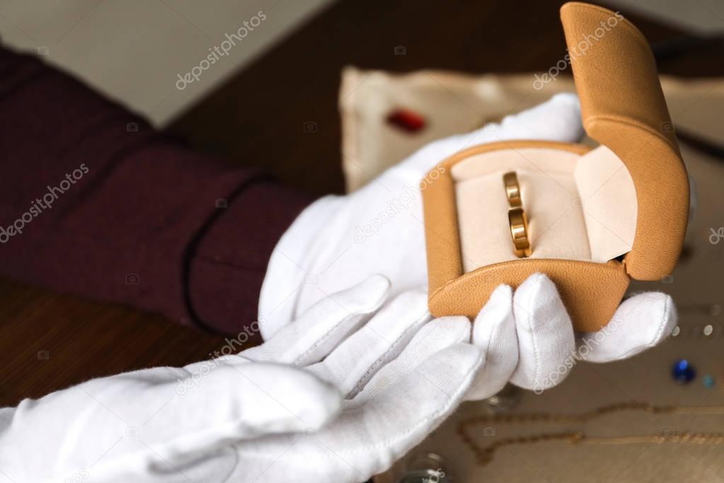 Jeweler holding box with rings, closeup