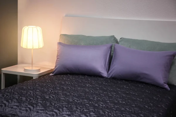 Cama confortável com travesseiros macios dentro de casa — Fotografia de Stock