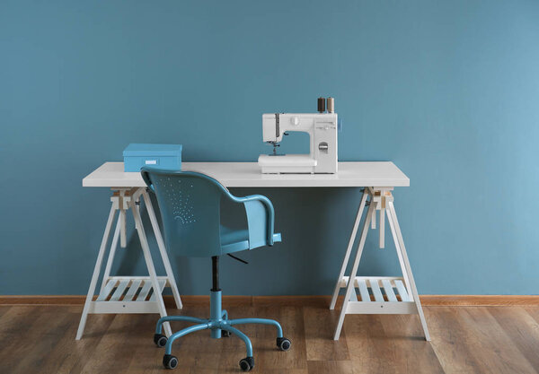 Sewing machine on table in tailor's workshop