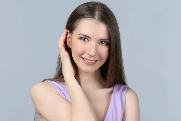 Portrait of beautiful smiling woman on light background — Stock Photo, Image