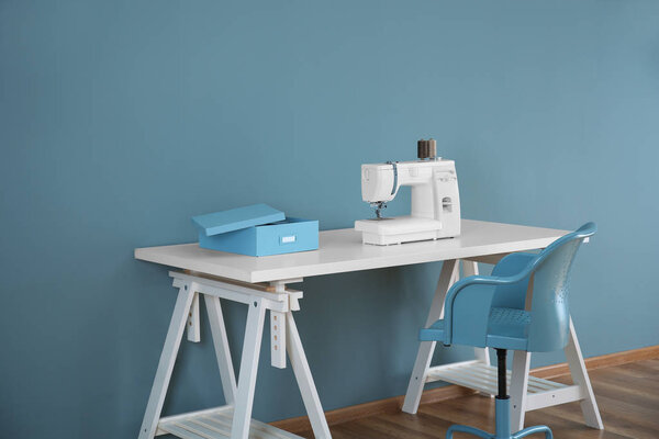 Sewing machine on table in tailor's workshop
