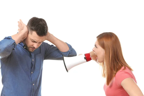 Angry woman with megaphone scolding her husband on white background — Stock Photo, Image