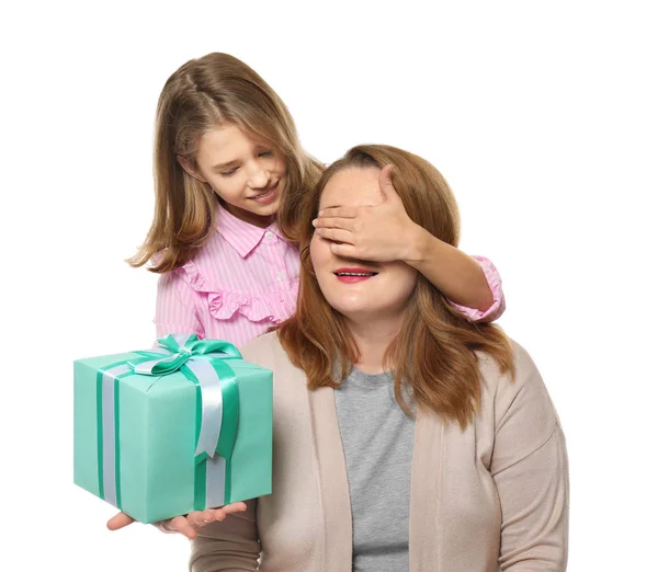 Cute little girl giving her mother present on white background — Stock Photo, Image