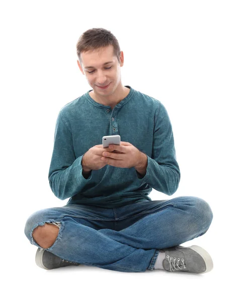 Jovem atraente com telefone celular no fundo branco — Fotografia de Stock