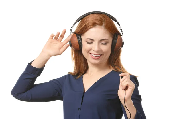 Retrato de una hermosa mujer sonriente escuchando música sobre fondo blanco — Foto de Stock