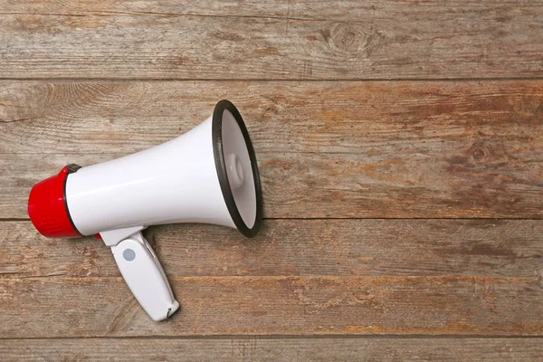 White megaphone on wooden background — Stock Photo, Image