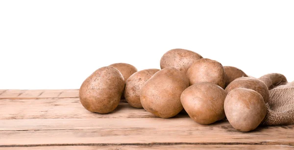 Patatas frescas crudas sobre mesa de madera sobre fondo blanco —  Fotos de Stock