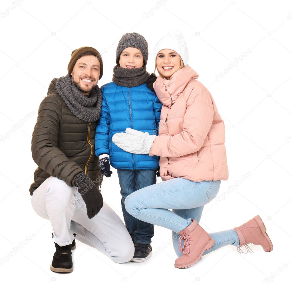 Happy family in warm clothing on white background. Ready for winter vacation
