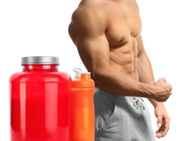 Jar with powder, shaker of protein cocktail and young bodybuilder on white background clipart