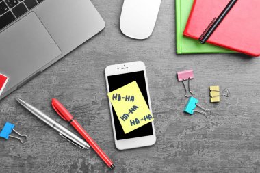 Smartphone ve yapışkan notu ofis Masası üzerinde. Nisan bir günü kutlama