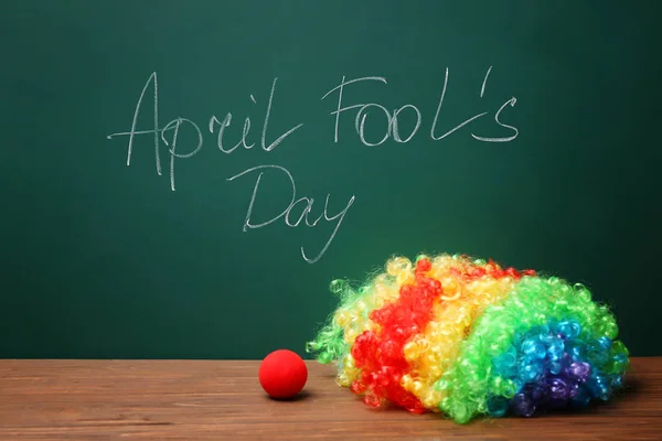 Clown Nose Rainbow Wig Table Chalkboard Written Phrase April Fools — Stock Photo, Image