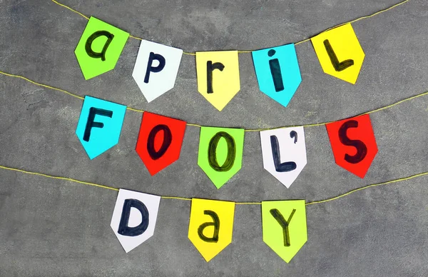 Kolorowe Flagi Frazą April Fools Day Szarym Tle — Zdjęcie stockowe