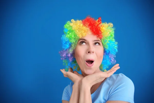 Young woman in funny disguise posing on color background. April fool's day celebration — Stock Photo, Image