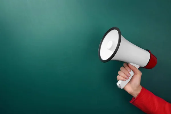 Woman holding megaphone near chalkboard — Stock Photo, Image