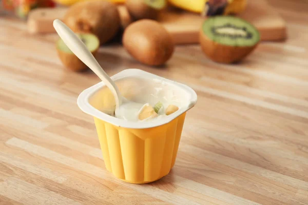 Plastový Kelímek Lahodný Jogurt Tropickým Ovocem Dřevěný Stůl — Stock fotografie