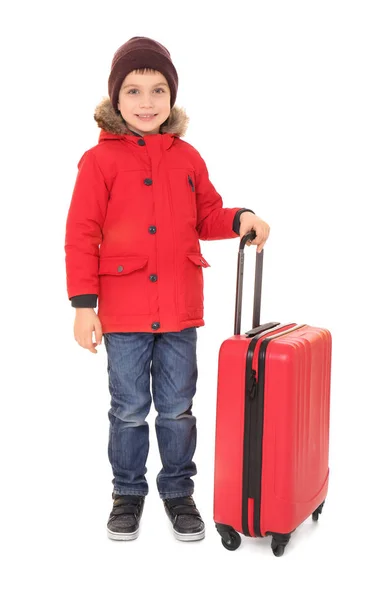 Cute little boy in warm clothing and luggage on white background. Ready for winter vacation — Stock Photo, Image