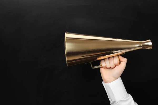 Man holding megaphone near chalkboard — Stock Photo, Image