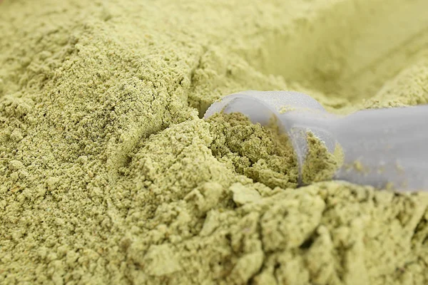 Hemp protein powder with scoop, closeup