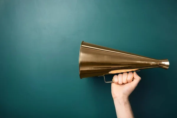 Man holding megaphone near chalkboard — Stock Photo, Image