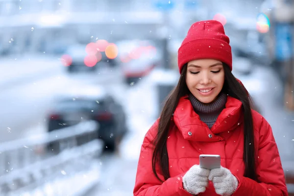 Piękna młoda kobieta z telefonu komórkowego na zewnątrz na zimowe wieczory — Zdjęcie stockowe