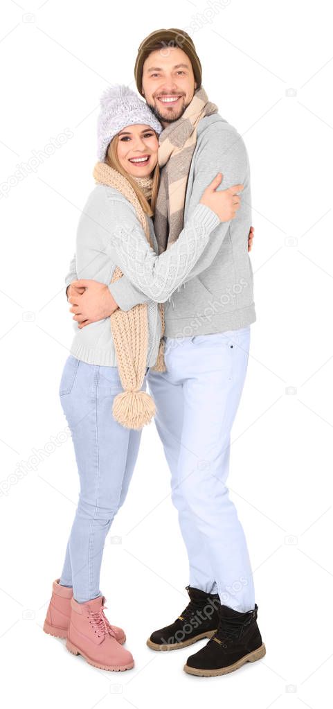 Young couple in warm clothing on white background. Ready for winter vacation