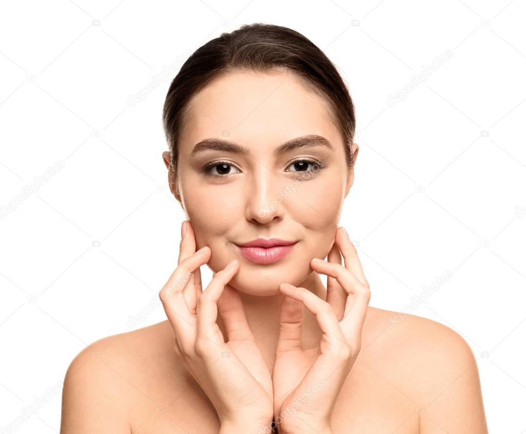 Portrait of beautiful young woman with clear skin on white background