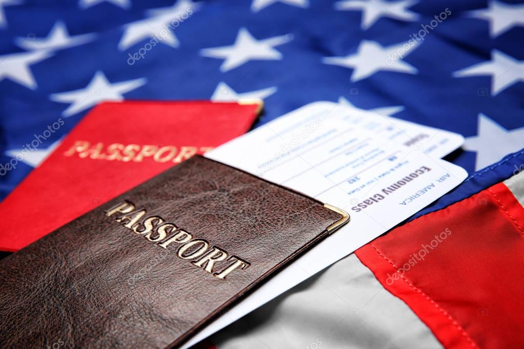 Passports and tickets on USA flag. American visa concept