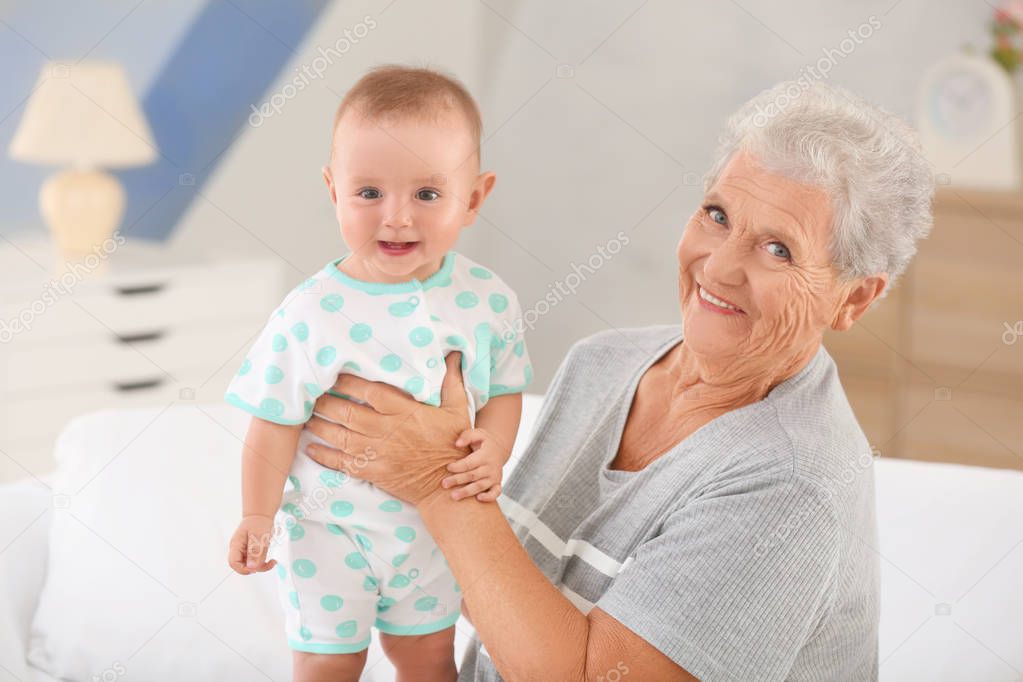 Senior woman with her little grandchild resting at home