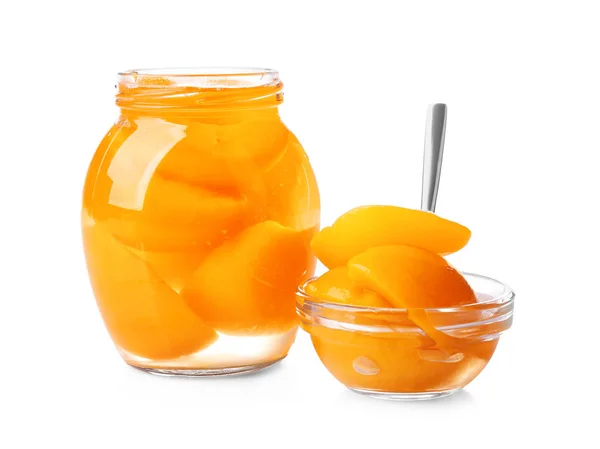 Jar and bowl with pickled apricots on white background — Stock Photo, Image