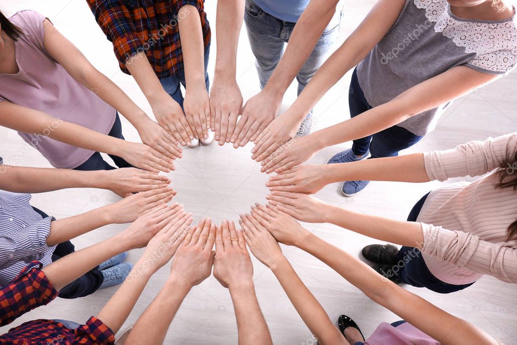 Young people making circle with their hands as symbol of unity