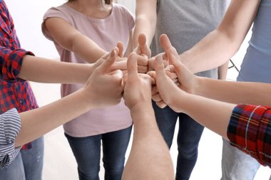 Grup daire içinde duran ve başparmak-up jest gösterilen insan. Birlik kavramı