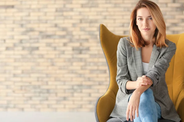 Young woman in armchair — Stock Photo, Image