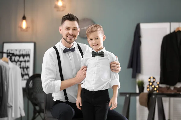 Father and son in elegant suits, indoors