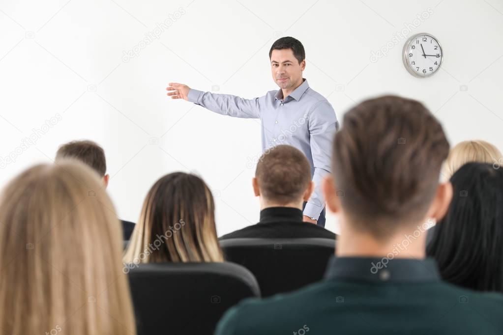 Group of people with business trainer at management seminar