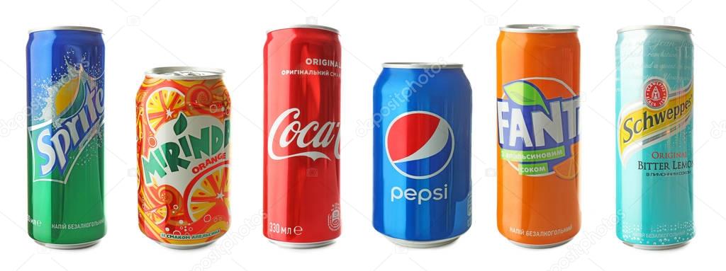 KYIV, UKRAINE - SEPTEMBER 18, 2017: Cans with drinks of different popular brands on white background